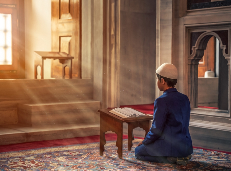 Person reading Quran in peaceful setting